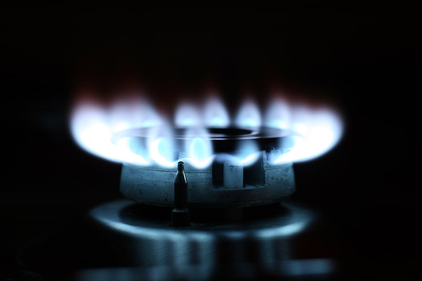 Close-up of blue gas stove flame on black background