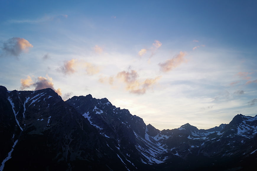 Dramatic Mountain Peaks at Sunset with Clouds