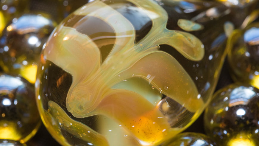 Close-up of Amber Glass Marbles with Swirling Patterns