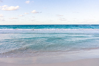 Turquoise Ocean Waves Rolling onto Sandy Beach