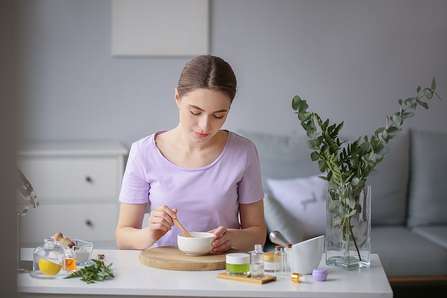 Woman mixing natural skincare ingredients at home