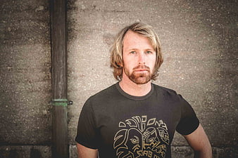 Portrait of a blonde bearded man in a black t-shirt