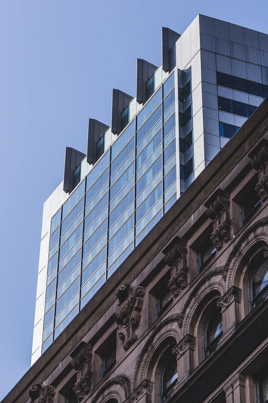 Modern Glass Skyscraper Behind Classic Stone Architecture