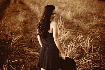 Woman in Polka Dot Dress Standing in Golden Field