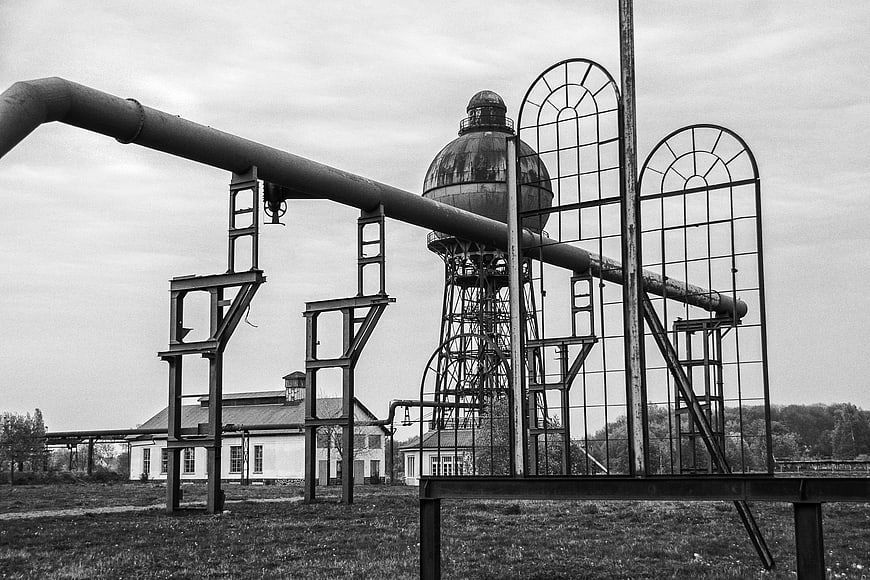 Black and white industrial water tower and pipes