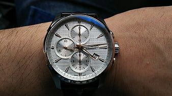Close-up of silver chronograph watch on wrist