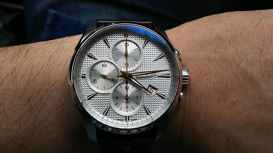 Close-up of silver chronograph watch on wrist