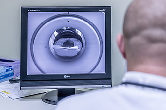 Doctor viewing MRI scan on computer monitor in medical office