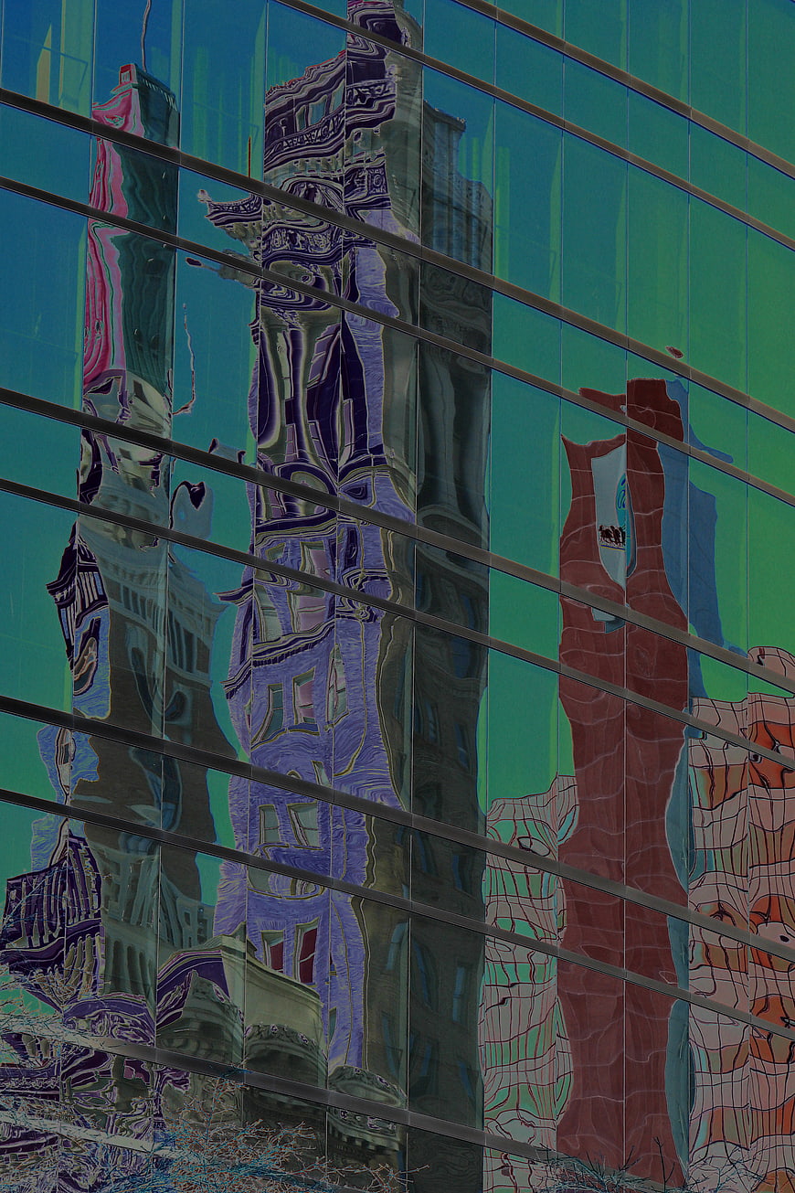 Abstract distorted city reflections on glass skyscraper facade