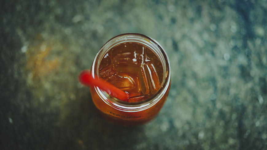 Top View of Iced Tea in Glass Jar with Red Straw