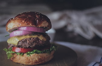 Close-up of Gourmet Cheeseburger with Red Onion and Lettuce