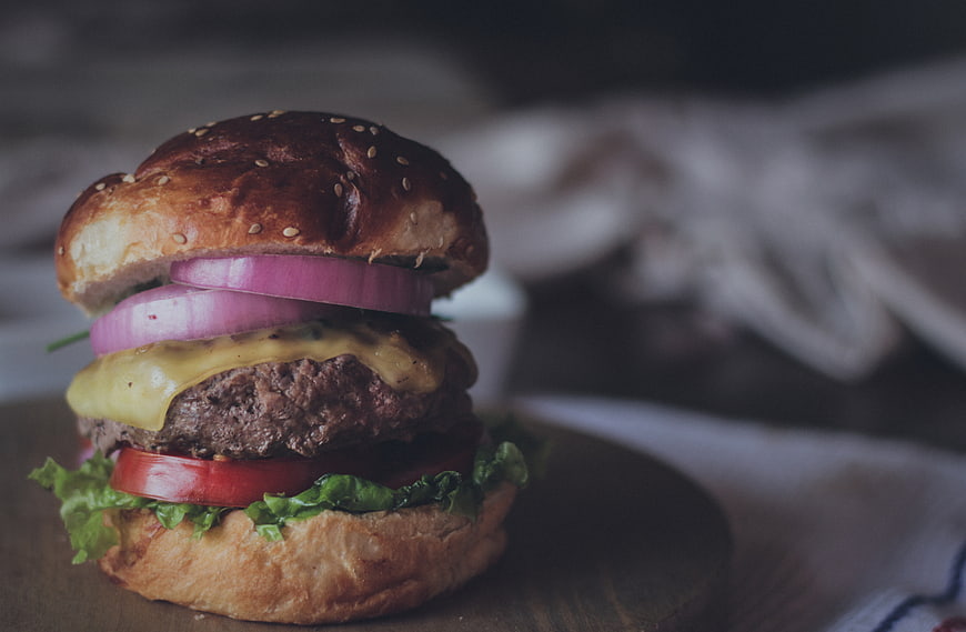 Close-up of Gourmet Cheeseburger with Red Onion and Lettuce