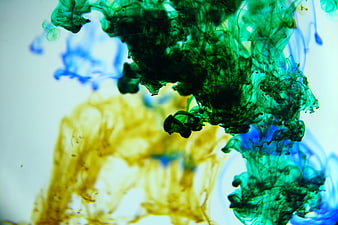 Abstract Green Blue And Yellow Ink Swirls In Water