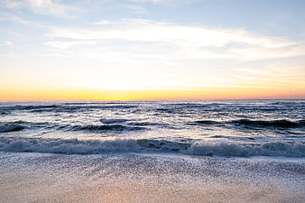 Serene Ocean Sunset with Gentle Waves and Golden Sky