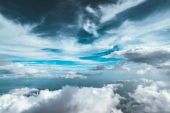Dramatic Aerial View of Turbulent Clouds and Blue Sky