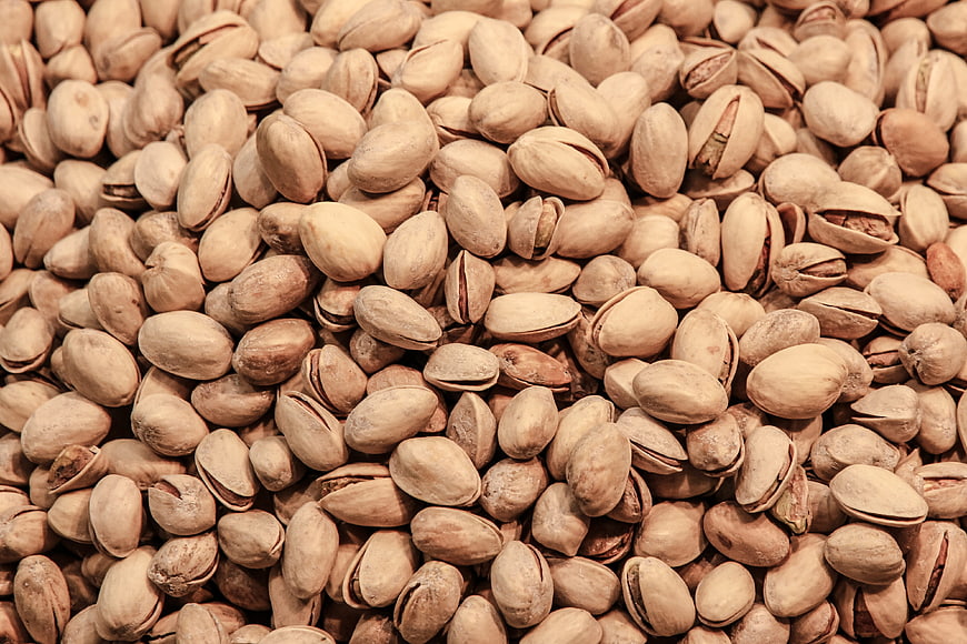 Close-up texture of shelled pistachios in shell