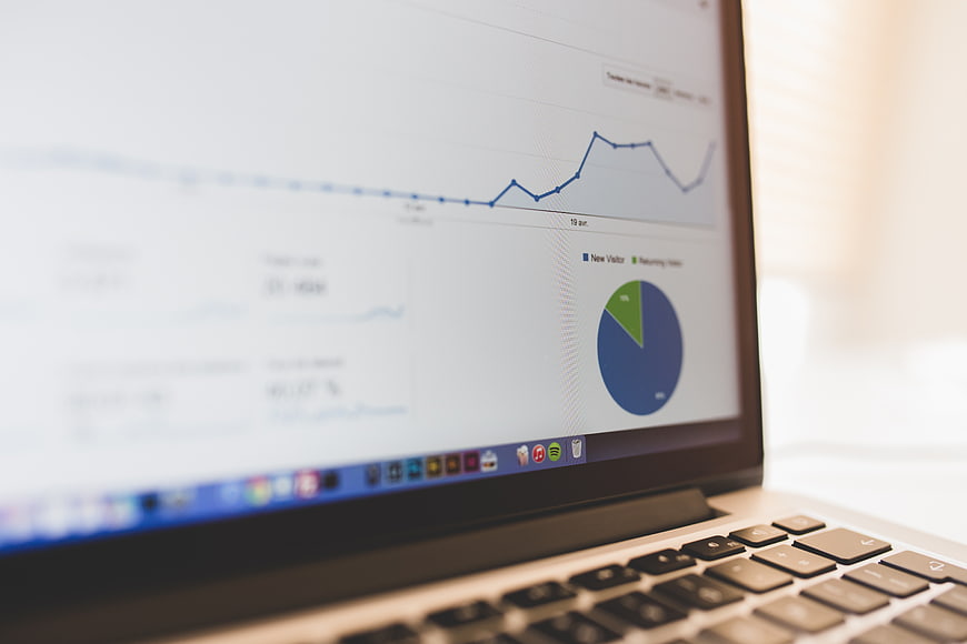Laptop Screen Showing Analytics Dashboard and Graphs