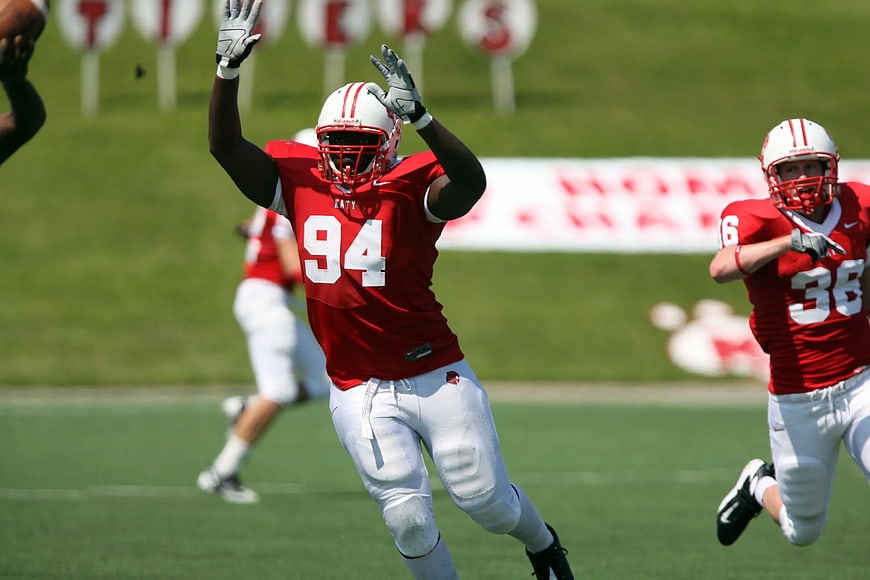 American Football Player Celebrating on Green Field