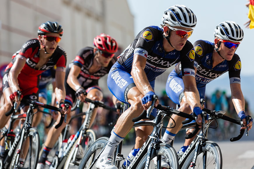 Professional Road Cyclists Racing On A Sunny Day