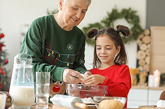 Grandmother and granddaughter baking Christmas cookies together