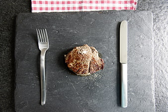 Grilled Steak on Slate Board with Cutlery and Checkered Napkin