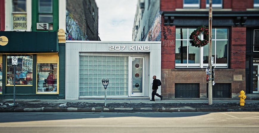 Urban street scene with modern storefront and pedestrian