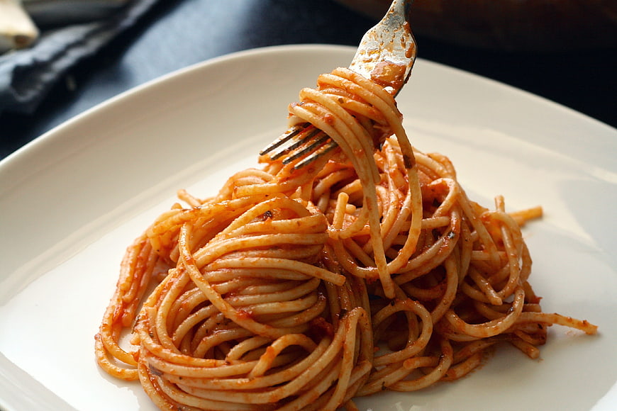 Close-up of spaghetti with tomato sauce on a fork