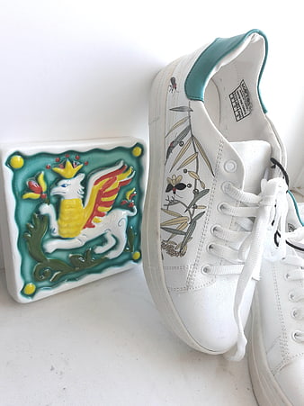 White sneakers with botanical print and ceramic griffin tile