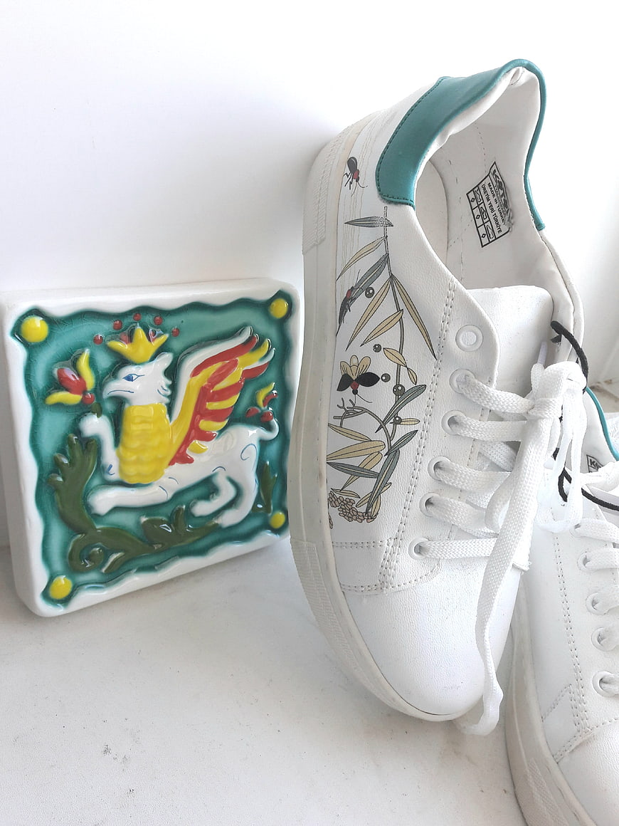 White sneakers with botanical print and ceramic griffin tile