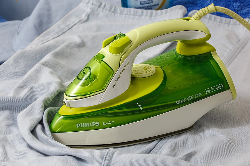 Green Philips EcoCare Iron on White Fabric