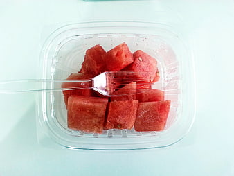 Top View of Cubed Watermelon in Plastic Container with Fork