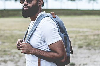 Stylish Bearded Man with Backpack and Sunglasses