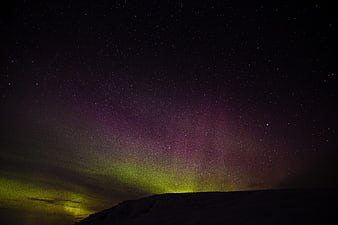 Vivid Aurora Borealis Over Silhouetted Mountain Ridge