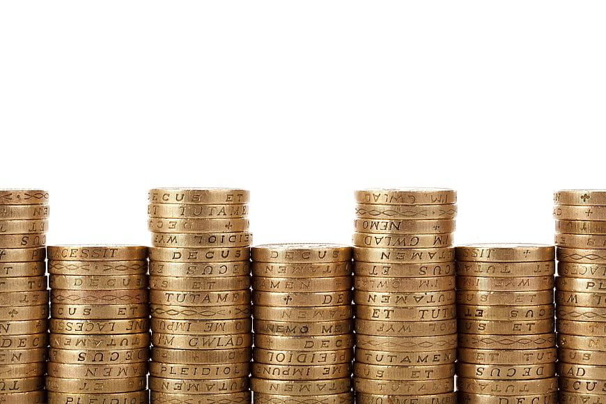 Stacks of gold coins on white background