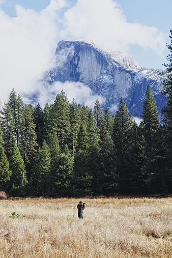 Photographer capturing Half Dome in Yosemite Valley landscape