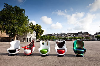 Colorful modern designer chairs in European town square