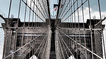 Low angle view of Brooklyn Bridge cables and stone tower