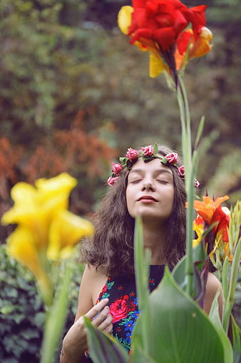 Woman with flower crown in garden portrait