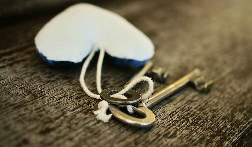 Vintage Keys and Heart Ornament on Wooden Background