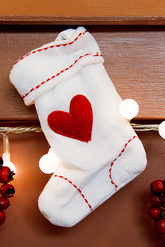 White Christmas Stocking With Red Heart On Wooden Shelf