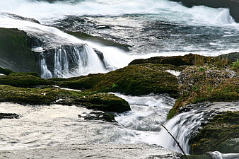 Mossy Rocks and Flowing Waterfall in Nature