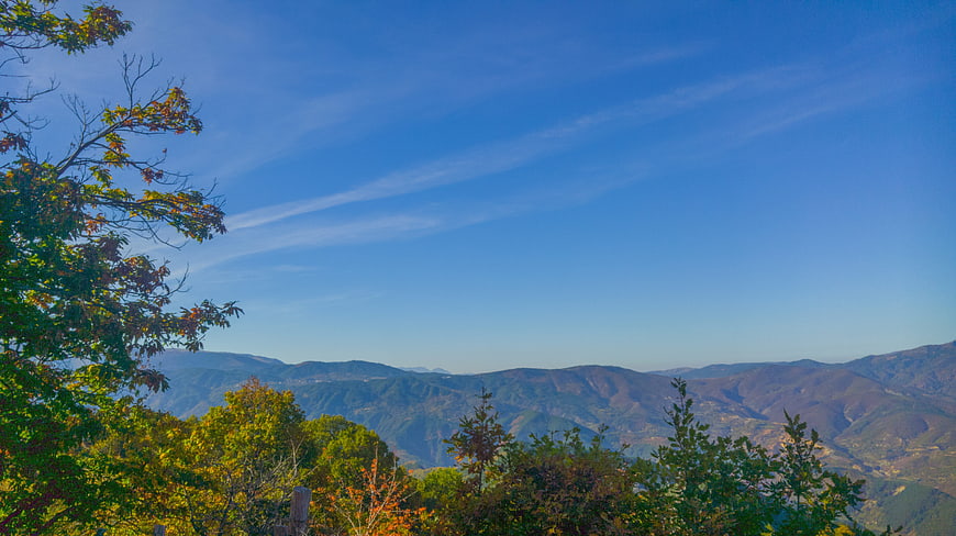 Scenic Mountain Landscape with Autumn Foliage and Blue Sky