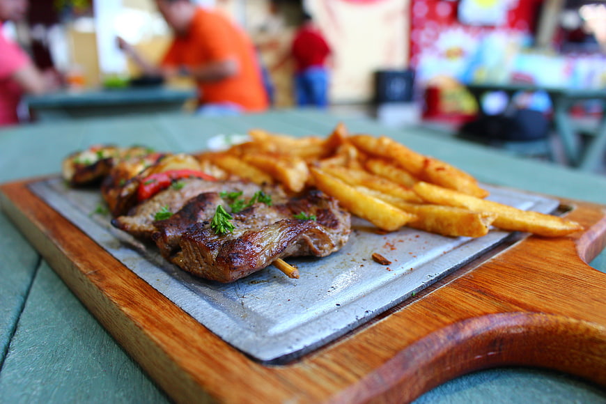 Grilled Steak and Fries on Wooden Board