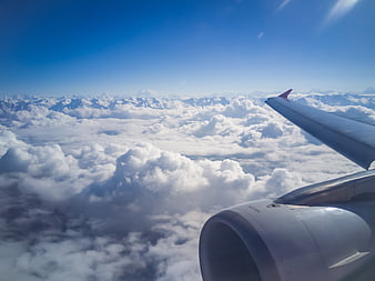 Aerial View of Himalayan Mountains and Clouds from Airplane Window