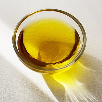 Top View of Golden Olive Oil in Glass Bowl