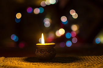 Traditional Diwali Clay Lamp with Colorful Bokeh Background