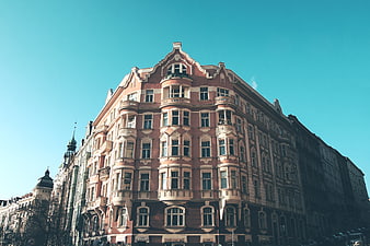 Historic Pink European Building with Ornate Facade and Blue Sky