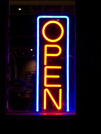 Vertical Neon Open Sign Glowing at Night