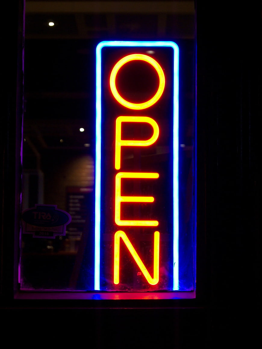 Vertical Neon Open Sign Glowing at Night