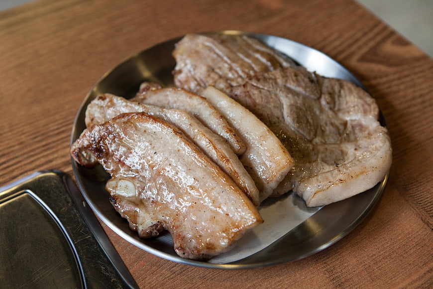 Sliced Grilled Pork Belly on Metal Plate